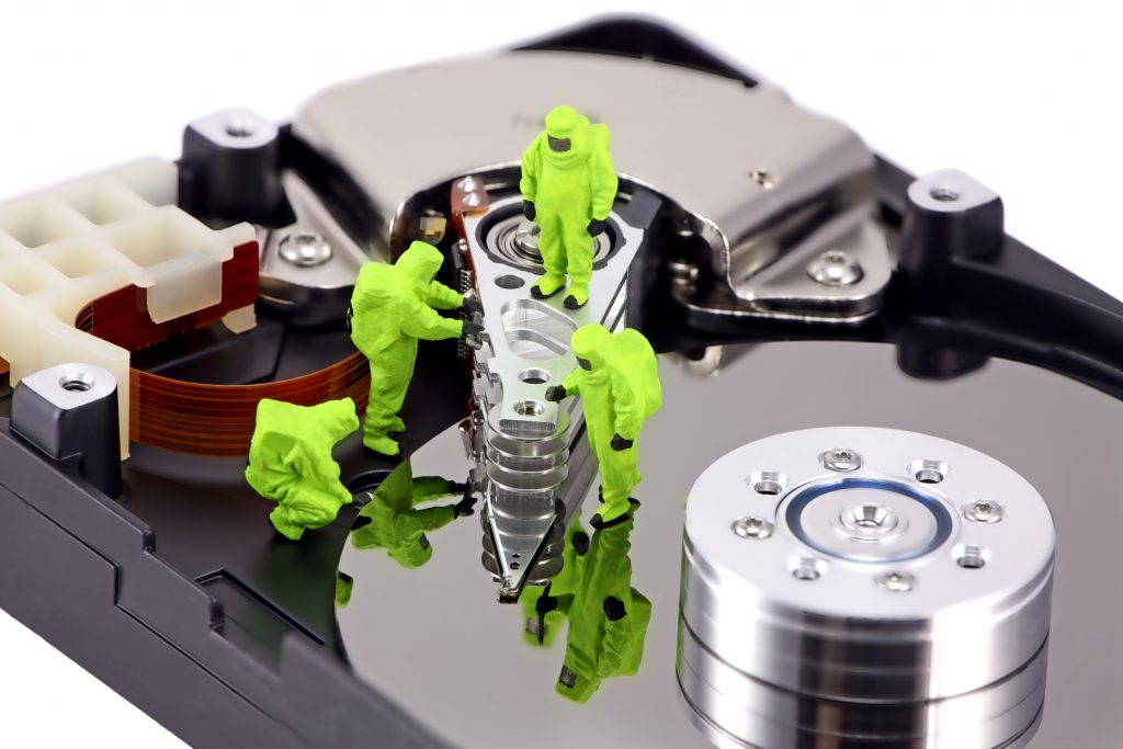 Concept image of a HAZMAT (Hazardous Materials) team closely inspecting a hard drive for viruses, spyware and trojans. Taken with a Canon 5D.